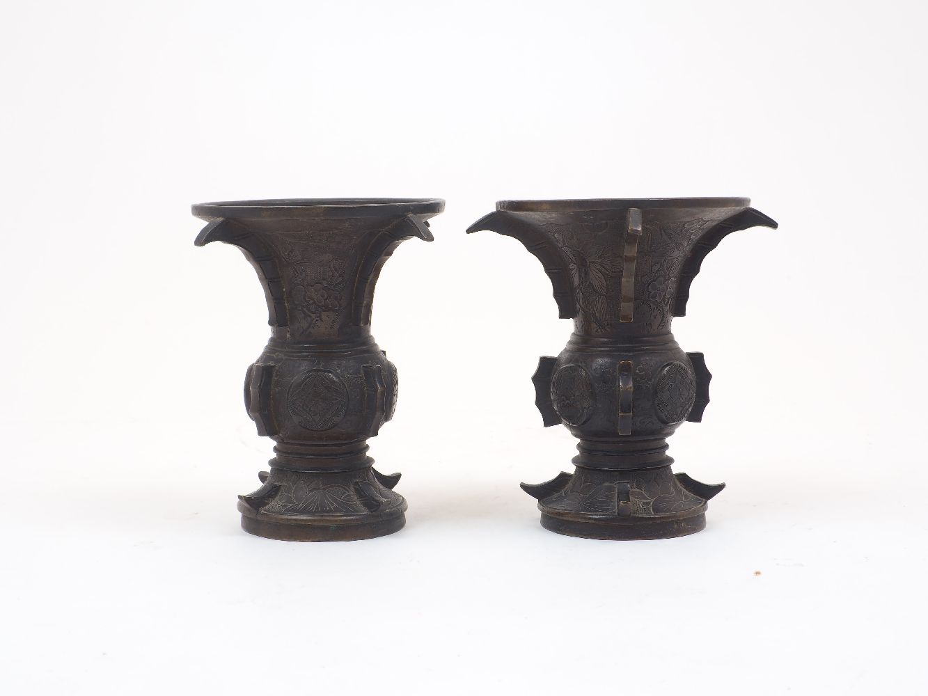 A pair of Japanese bronze vases, Meiji period, of an archaistic Zun shape with flaring rim and