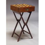 A mahogany games box on stand, with reversible top, having parquetry chessboard to one side, with