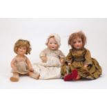 A group of 20th Century dolls, to include a German doll with composite head, marked HW, on a ball-