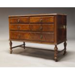 A walnut chest of drawers, early 20th Century, with two short over two long drawers, on turned