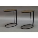 A pair of contemporary oval side tables, of recent manufacture, with hammered brass tops on black