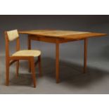 A teak extending dining table, c.1960, the rectangular top with one additional leaf, on