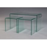 A contemporary set of nesting glass side tables, each formed from one piece of glass, largest - 46cm