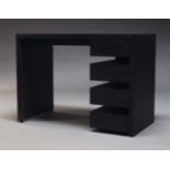 A contemporary ebonised desk, of recent manufacture, the rectangular top above a bank of four