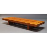 A contemporary cherry wood veneered low coffee table, of recent manufacture, with rectangular two