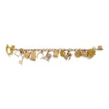 A charm bracelet, the fancy link chain suspending thirteen 9ct gold charms and a single heart shaped