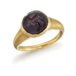 A Sassanian gold and garnet finger ring, the cabochon garnet seal stone engraved with a bird to a