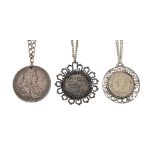 Three coin pendant necklaces, comprising: a pendant mounted reproduction 8 reale coin; a pierced