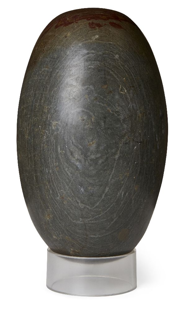 A polished lingham stone, of typical ovoid form, 34cm. long Provenance: Formerly in the collection