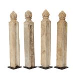 Four Mughal columnar shaped carved marble posts with finials in the shape of a closed lotus bud,