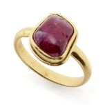 A ruby-set gold ring, South India, in a modern gold setting, the polished pebble stone of almost