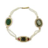 A gem-set jade and seed pearl bracelet, India, late 19th century, with three jade elements set