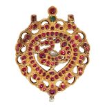 An exceptional ruby-set gold peacock pendant, South India, 18th century, of drop form, with two
