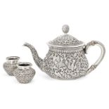 A silver repousse Kutch teapot, India, circa 1860 and two silver spice containers, of squat form