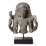 A black stone sculpture of Shiva, India, 19th century in a 10th century style, carved wearing a