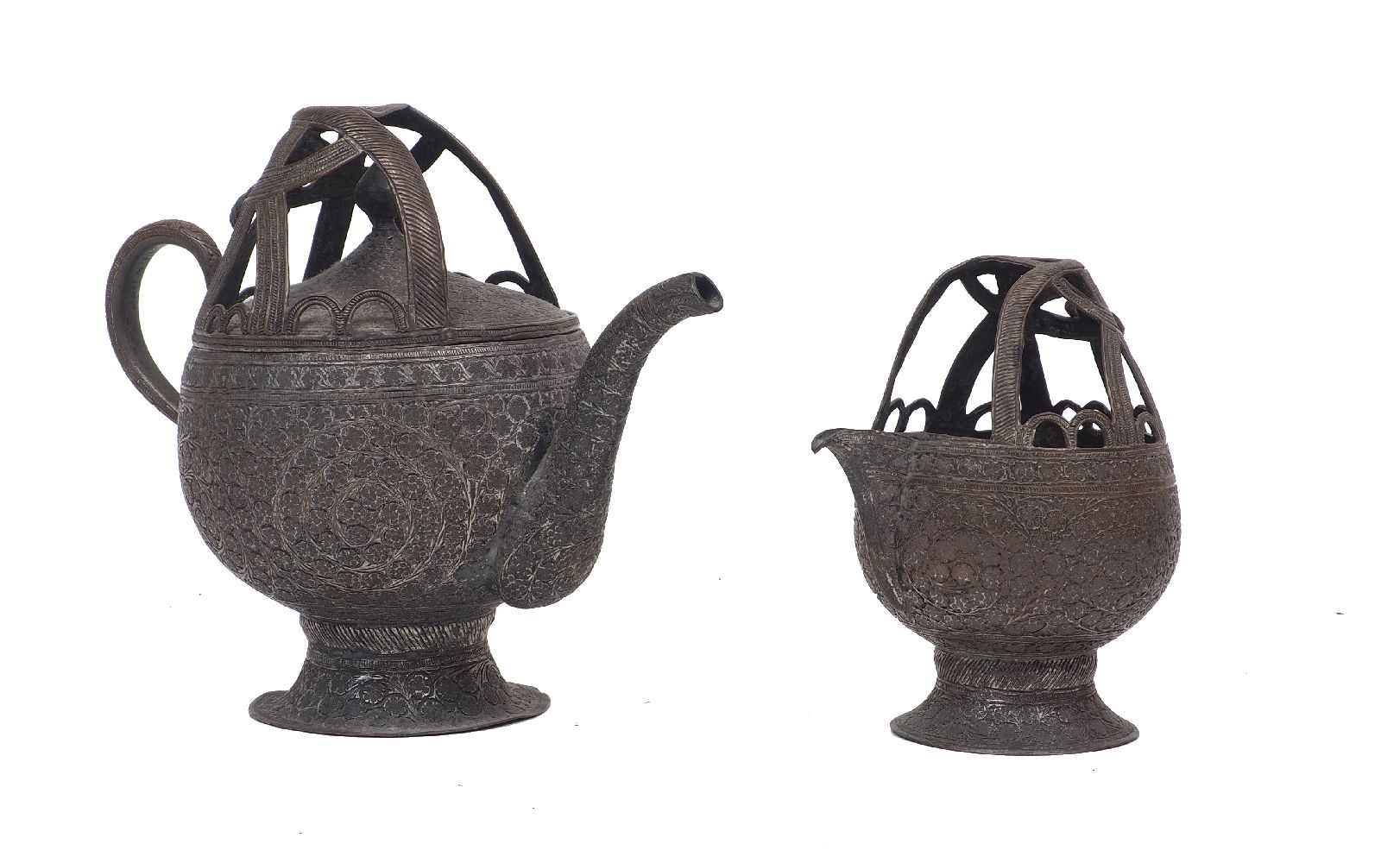 An Islamic silvered copper tea pot and jug, late 19th/20th century, 20cm and 14cm high (2)Please