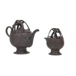 An Islamic silvered copper tea pot and jug, late 19th/20th century, 20cm and 14cm high (2)Please