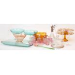 A group of glassware, comprising: an amber Belce cake stand, a further amber glass cake stand, an