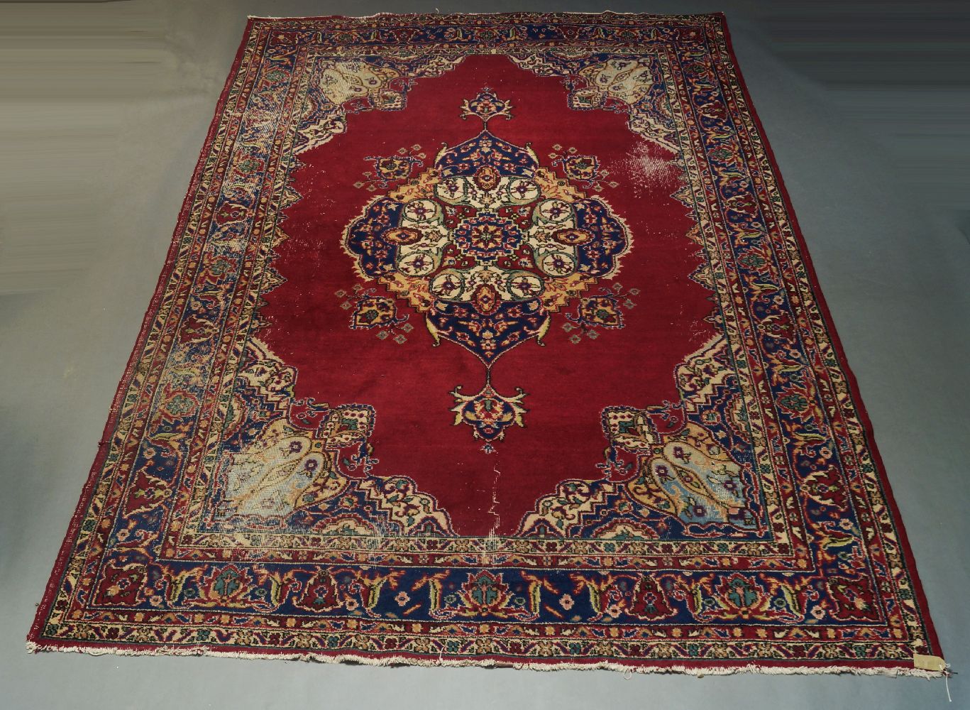 A Kazak rug, early to mid 20th Century, with six hook edged medallions in a red field, 260cm x 128cm - Image 2 of 3