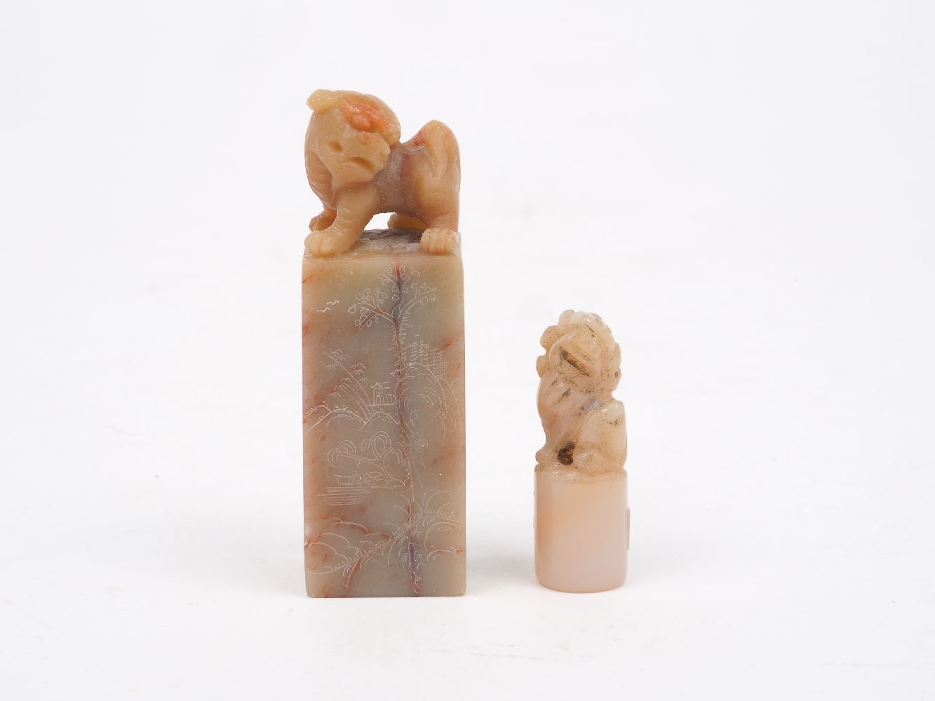 Two Chinese soapstone seals, 20th century, one carved as a mythical beast atop a stand with