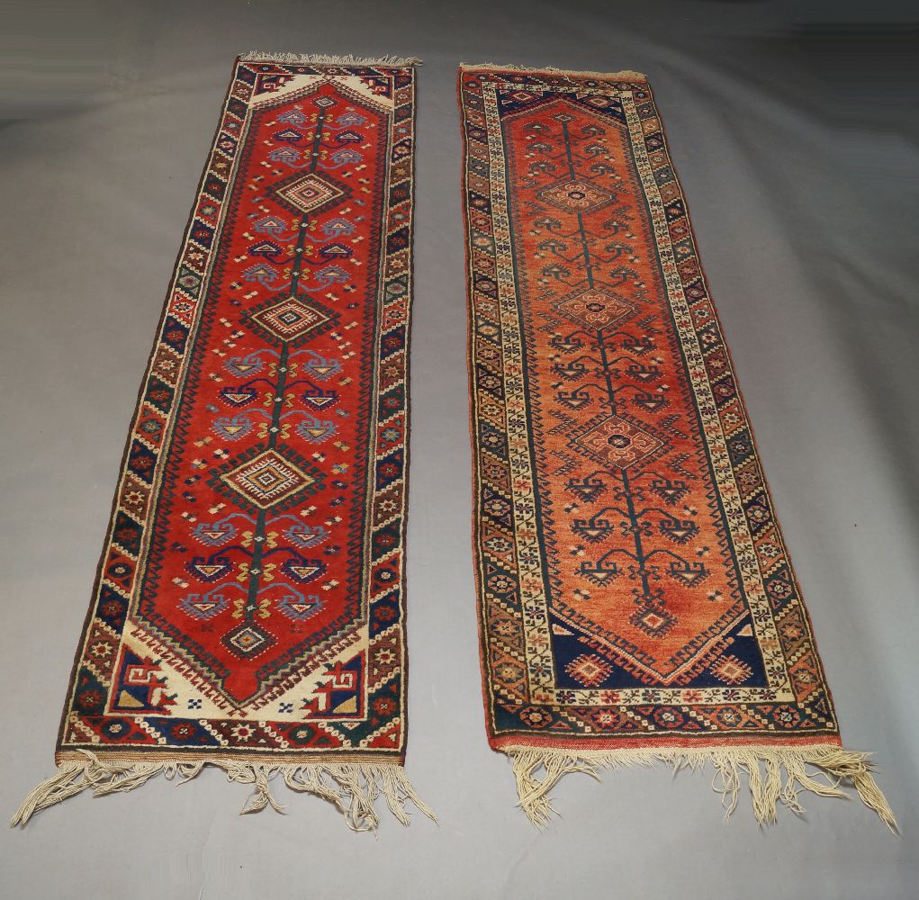 Two Turkish runners, with deep red fields, a pair of rugs with three medallions and two other rugs