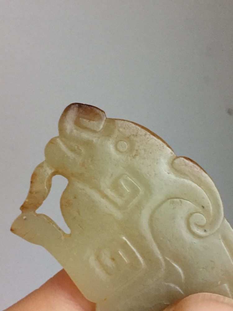 A rare Chinese yellow jade pendant, Western Zhou dynasty, carved as a stylised mythical beast with a - Image 6 of 11