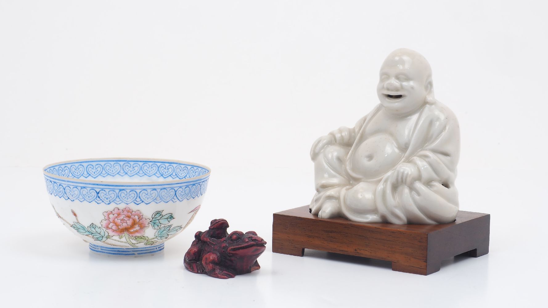 A Chinese Dehua porcelain figure of Budai, early 20th century, modelled seated in a relaxed