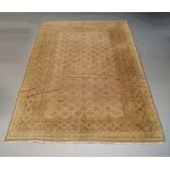 A Belouch design rug, mid 20th Century, with fawn coloured field and borders, 293cm x 205cm (VAT