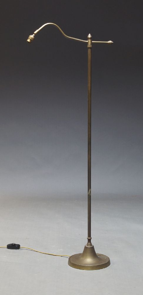An adjustable brass standard lamp, early to mid 20th Century, the curved arm on height adjustable