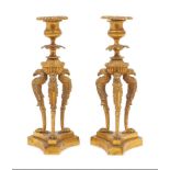 A pair of Regency style gilt metal candlesticks, early 20th century, each cast with three griffin-