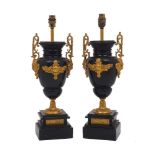 A pair of French slate gilt metal mounted urn-form table lamps, early 20th century, with mask and