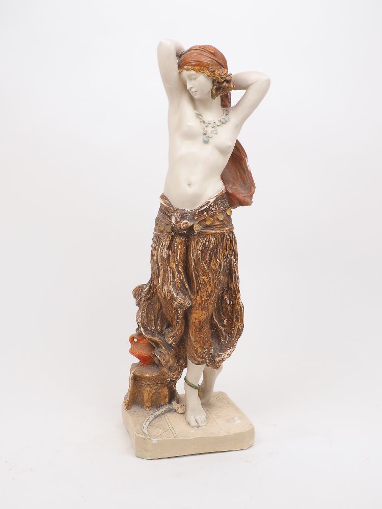 A large polychrome plaster figure of a semi-nude odalisque with a vase and sabre at her feet, 20th