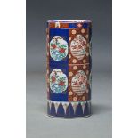 A Japanese ceramic stick stand, late 20th Century, of cylindrical form, in Imari colour way,