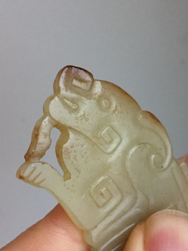A rare Chinese yellow jade pendant, Western Zhou dynasty, carved as a stylised mythical beast with a - Image 7 of 11