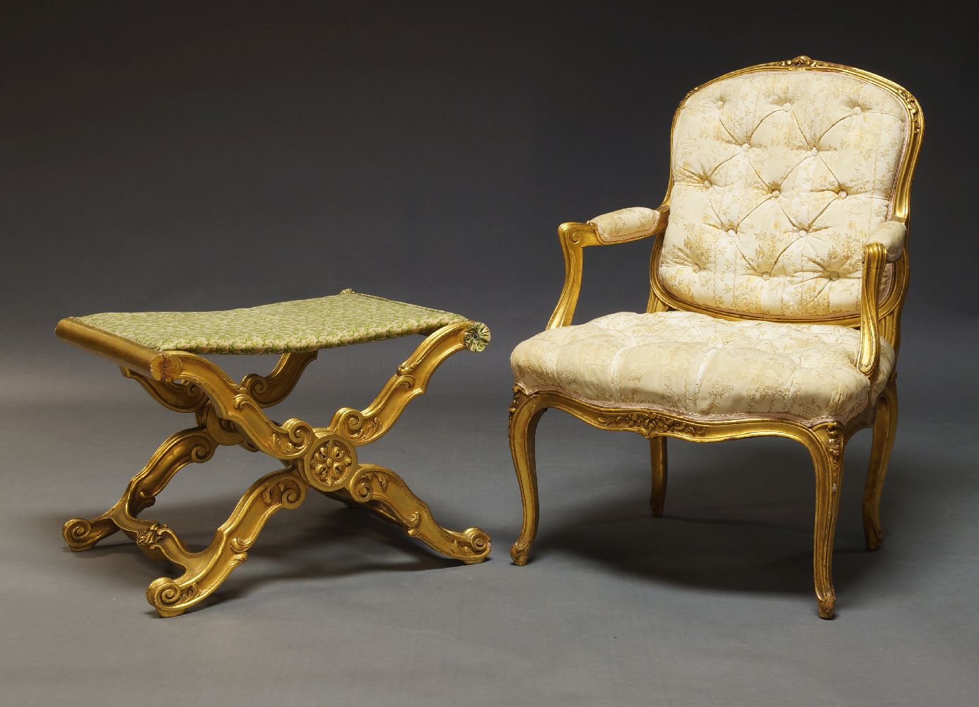 A Louis XV style gilt fauteuil, mid 20th Century, the cartouche shaped backrest with floral carved