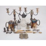 A group of silver plated items including: a pair of three branch candelabra candlesticks, a glass