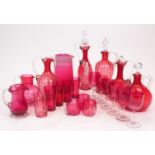 A quantity of Victorian cranberry glass, comprising; five decanters, the tallest 31cm high, three