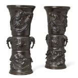 A pair of large Japanese bronze sleeve vases, Meiji period, each cast to the central section with