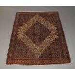 A Shiraz rug, early to mid 20th Century, with ivory lozenge in an ivory field with all over floral