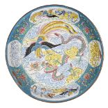 A Chinese Canton enamel dish, 19th century, painted with a dragon and phoenix amidst clouds, 36cm