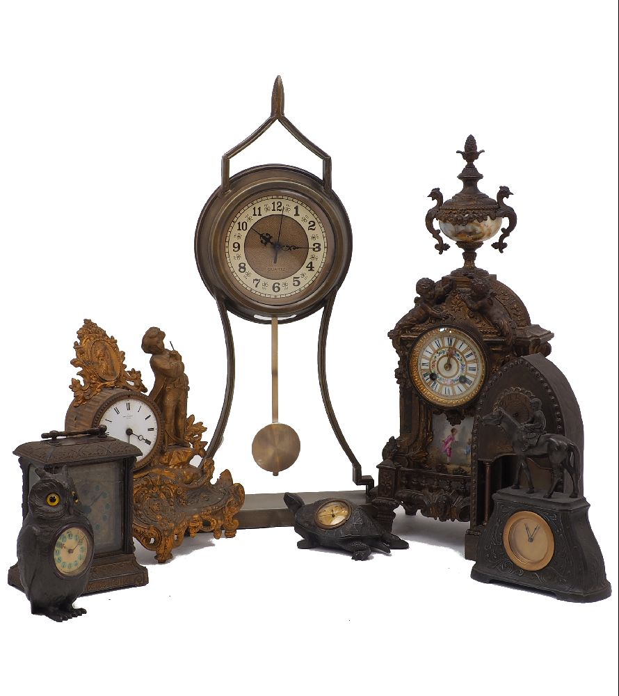 A group of seven spelter and brass mantle clocks and timepieces, 20th century, comprising: a