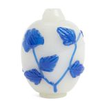 A Chinese Peking blue-overlay glass snuff bottle, late 19th century, carved with blooming lotus