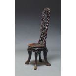 A South East Asian carved high back chair, the pierced back decorated with carved dragons, above