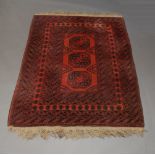 A Tekke rug with three rows of guls in a deep red field, 142cm x 110cm and another, 176cm x 125cm