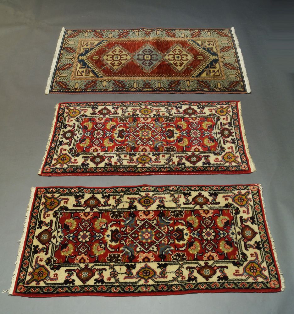 A Kazak rug, early to mid 20th Century, with six hook edged medallions in a red field, 260cm x 128cm - Image 3 of 3