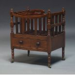 A Victorian mahogany Canterbury, with four divisions and pierced handle, having drawer to base, on