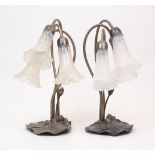 A pair of Art Nouveau spelter three branch desk lamps, late 20th century, cast with lily pad base