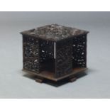 A South East Asian revolving hardwood book stand, of square form, the top with carved dragons and