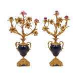 A pair of French gilt metal mounted floral three branch candlesticks, 20th century, modelled as a