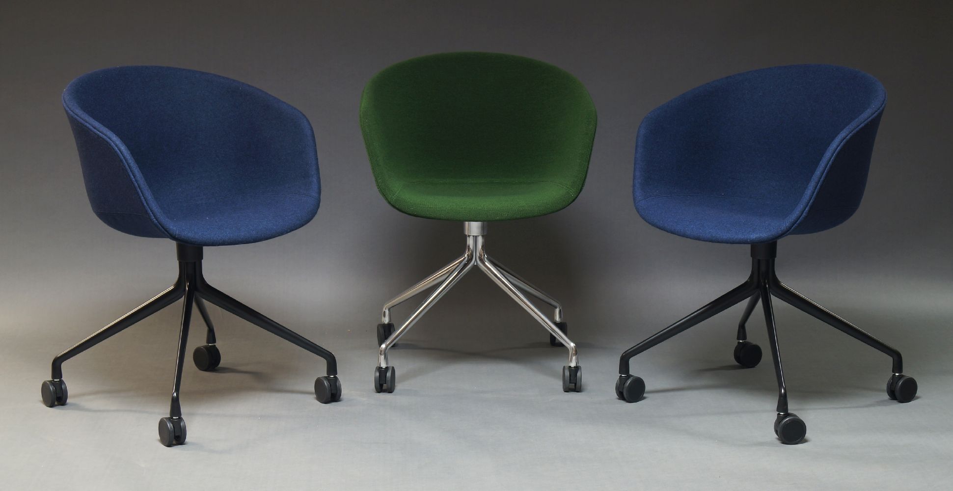 Hay, Three 'AAC 24' swivel chairs, of recent manufacture, two with blue upholstered seats, on